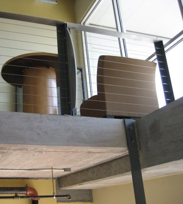 The industrial look: plate glass windows, exposed ductwork, pipes and wiring, and metal accents.